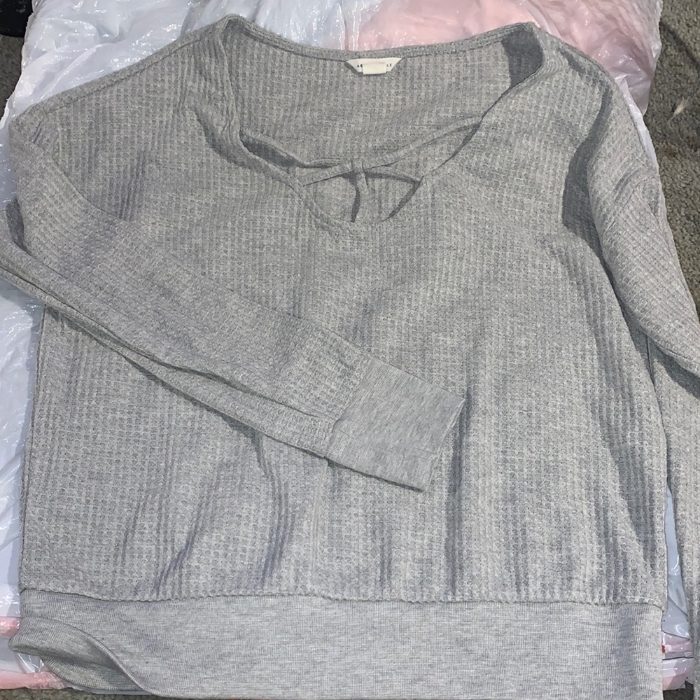 Gray long sleeve with cutout Over chest area